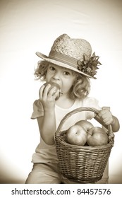 Child Eating Apple In Studio. Vintage Toned