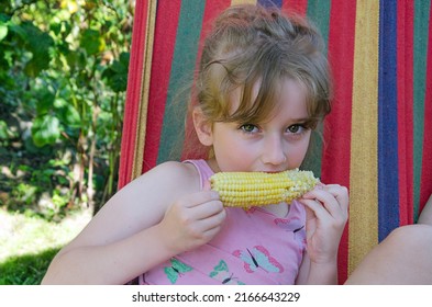 Child Eating Boiled Corn, Portrait Of A Little Girl Who Eats Sweet, Boiled Corn