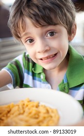 Child Eating A Bowl Of Macaroni And Cheese