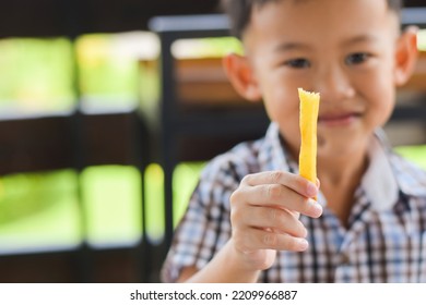 Child Eating French Fries Or Potato Chips.