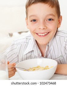 Child Eating Frosted Flakes At Breakfast