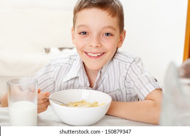 Child Eating Frosted Flakes At Breakfast