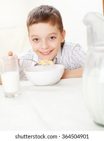 Child Eating Frosted Flakes At Breakfast