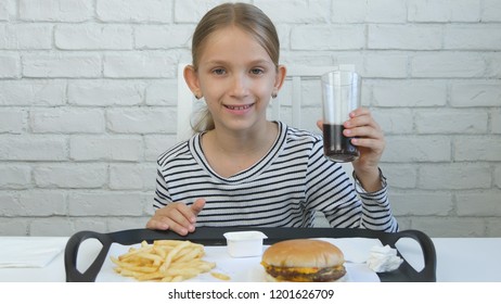 Child Eating Hamburger In Restaurant, Kid And Fast Food, Girl Drinking Juice