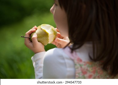 Child Eating Healthy Pear