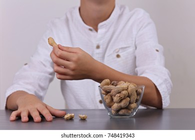 Child Eating Peanuts. Food Allergy Concept