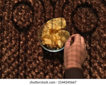 Child Eating Potato Chips In The Sun