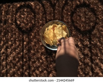 Child Eating Potato Chips In The Sun