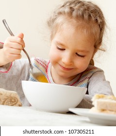 Child Eating Soup At Home. Little Girl Have A Dinner