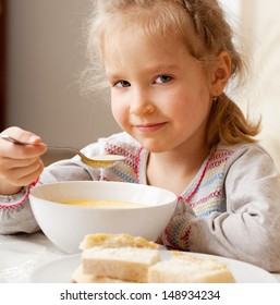 Child Eating Soup At Home. Little Girl Have A Dinner