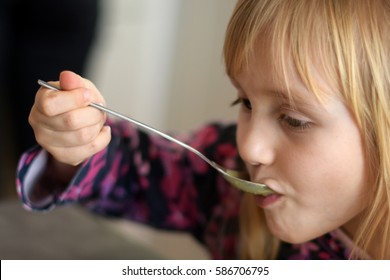 Child Eating Soup At Home. Little Girl Have A Dinner