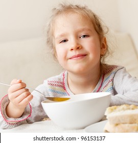 Child Eating Soup At Home. Little Girl Have A Dinner