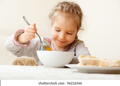 Child Eating Soup At Home. Little Girl Have A Dinner