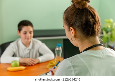 Child Eating Stealthily High Calorie Foods. Obesity, Health Problem, Weight Loss. Doctor Advising A Fat Boy To Eat Healthy. Prescribing Diet For Overweight Fat Patient. Doctor Warning Of Consequences.