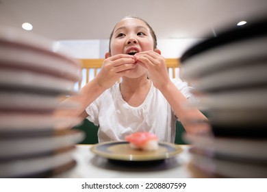 Child Eating Sushi At Conveyor Belt Sushi