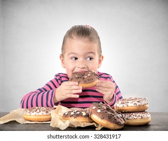 Child eating sweet chocolate donuts,selective focus 