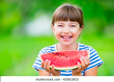 Child Eating Watermelon In Garden. Pre Teen Girl With Teeth Braces. 