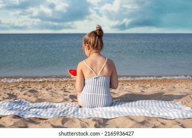 Child Eating Watermelon On The Beach In Summer Sunny Day. Little Girl Back