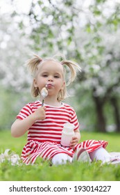Child eating yogurt in a spring floral park