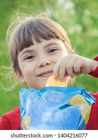 child eats chips. selective focus. food and drink.