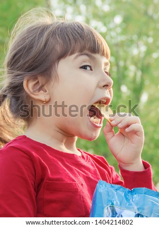 child eats chips. selective focus. food and drink.