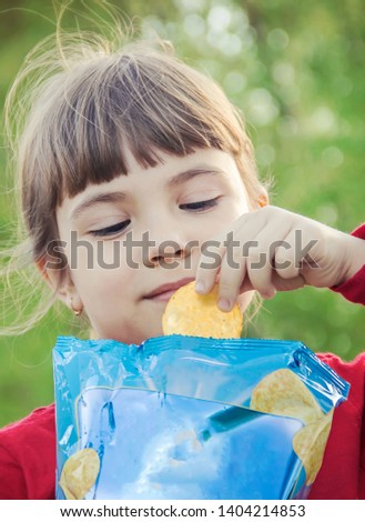 child eats chips. selective focus. food and drink.