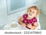 The child eats dumplings at the table. Selective focus. Kid.