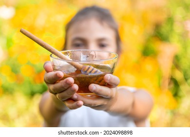 The child eats flower honey. Selective focus. Nature. - Shutterstock ID 2024098898