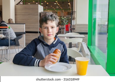 The Child Eats In The School Cafeteria   