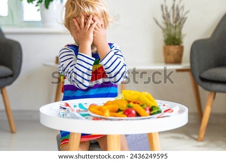 Child eats vegetables at home. Selective focus. Food.
