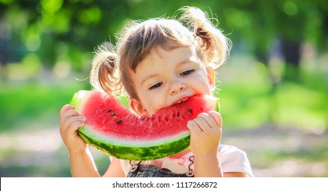 A Child Eats Watermelon. Selective Focus.