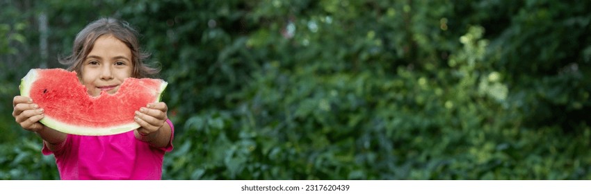 A child eats a watermelon. Selective focus. Nature - Powered by Shutterstock