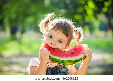 A child eats watermelon. Selective focus. - Shutterstock ID 662508823