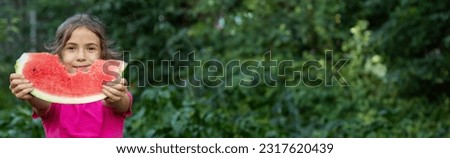 A child eats a watermelon. Selective focus. Nature