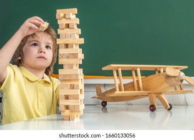 Child Education. Kid Playing Jenga Game At Home. Cute Little Preschool Kid Boy In A Classroom. Individual Tutoring. Kid Gets Ready For School