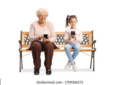 Child and an elderly woman sitting on a bench and typing on mobile phones isolated on white background - Powered by Shutterstock