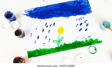 The child is engaged in drawing. ?reative development of the kid through painting with paints. Colored children's education background.