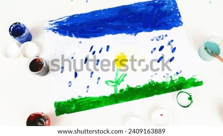 The child is engaged in drawing. ?reative development of the kid through painting with paints. Colored children's education background.