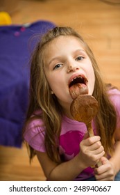 Child Enjoying Licking Melted Milk Chocolate.