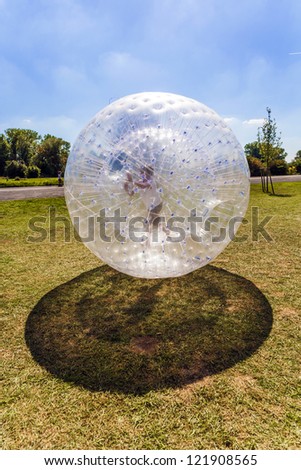 child enjoys rolling the zorbing ball