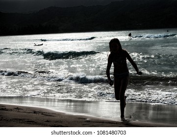 Child Exiting The Water After A Moonlight Swim.