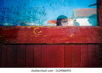 A Child Expressing Fear Watching Outside