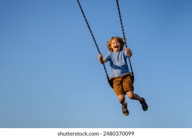 Child extreme swinging. Danger high Swing in sky. Child having fun on a swing outdoor. Craziness and freedom. Kid playing on swing-set outdoor. Playful child swinging very high to the sky.