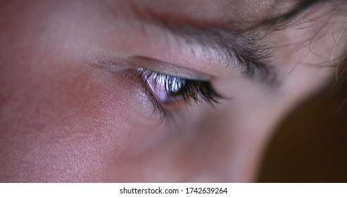 
Child Eye Close-up Tablet Screen Display. Young Boy Eyes Staring At Blue Light At Night