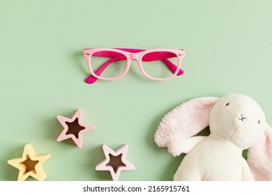 Child Eyeglasses Over Pastel  Background. Optical Store, Glasses Selection For Kids, Eye Test, Vision Examination At Optician Concept. Top View, Flat Lay