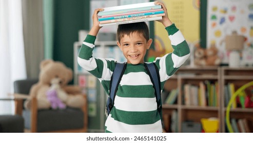 Child, face and book on head with laugh in classroom for learning education for back to school, library or alphabet. Boy, kid and happy laughing for future academic with funny joke, student or story - Powered by Shutterstock