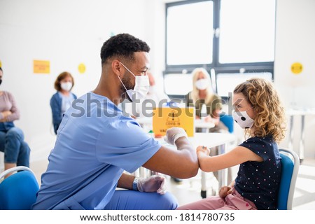 Child with face mask getting vaccinated, coronavirus, covid-19 and vaccination concept.