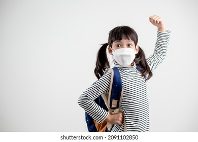 Child with face mask going back to school after covid-19 quarantine and lockdown. - Shutterstock ID 2091102850