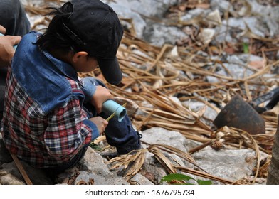 The child farmer has connected the water pipe system to use in his coffee farm business. Including the selection of food plants for household consumption - Shutterstock ID 1676795734