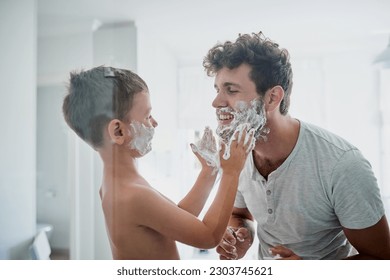 Child, father and learning to shave, smile and bonding together in home bathroom. Happy, dad and teaching kid with shaving cream on face beard, playing or cleaning, hygiene or enjoying hair removal. - Powered by Shutterstock